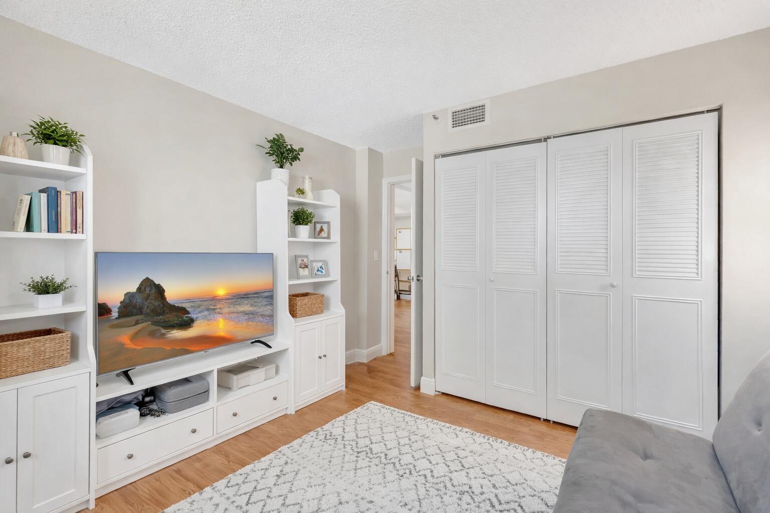 5260 Northwest 2nd Avenue, Unit 307 Boca Raton, FL 33487 - Photo 12 of 16 a living room with furniture and a closet