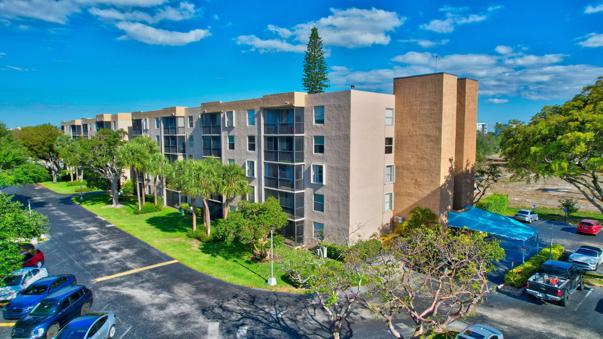 5260 Northwest 2nd Avenue, Unit 307 Boca Raton, FL 33487 - Photo 16 of 16 a front view of a building with garden