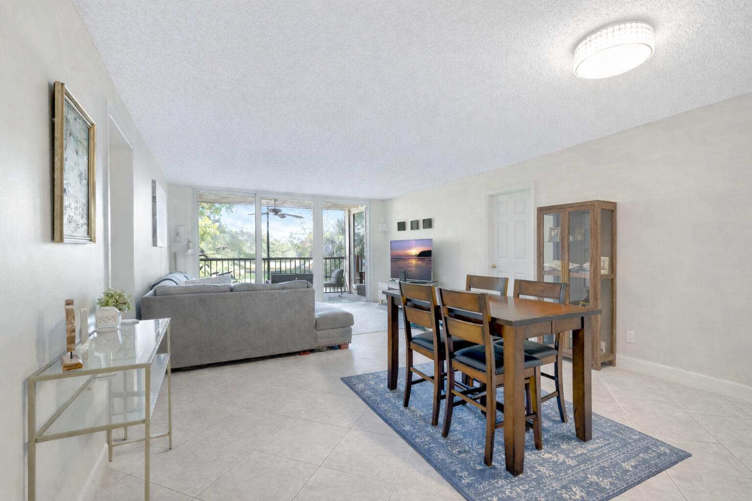 5260 Northwest 2nd Avenue, Unit 307 Boca Raton, FL 33487 - Photo 5 of 16 a view of a dining room with furniture and a large window