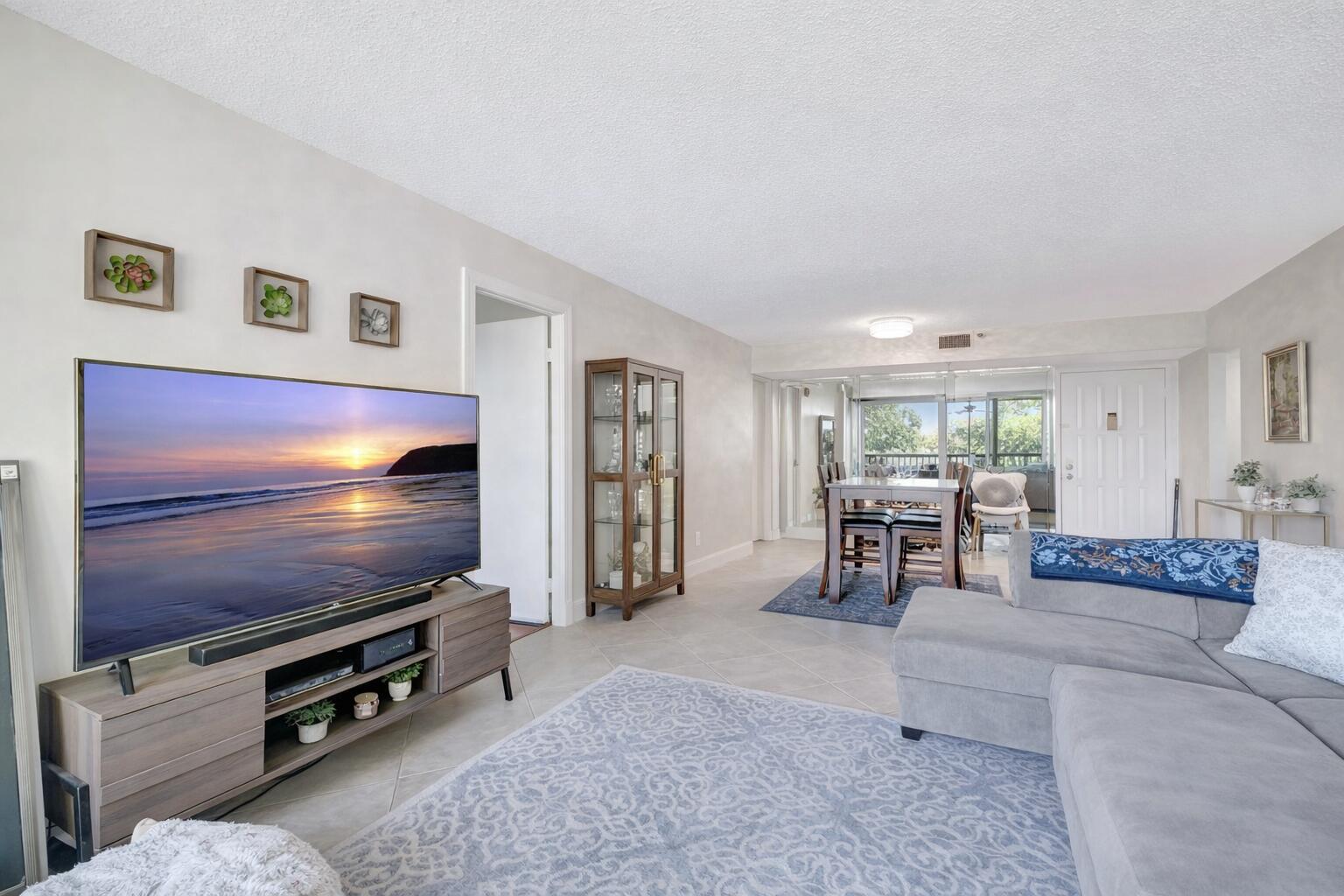 5260 Northwest 2nd Avenue, Unit 307 Boca Raton, FL 33487 - Photo 6 of 16 a living room with furniture and a flat screen tv