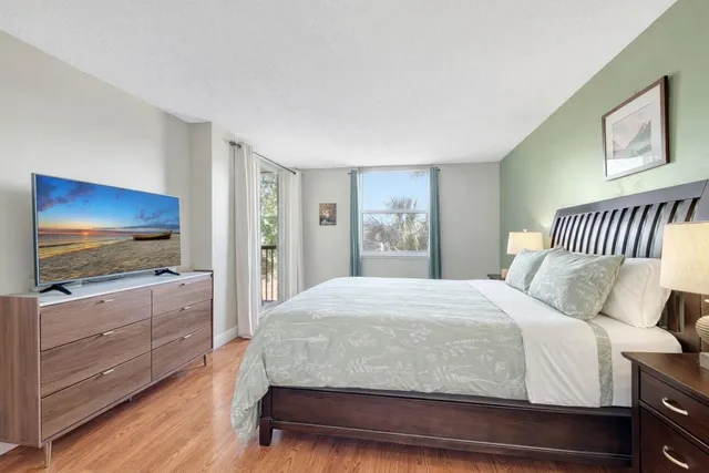 a bedroom with a large bed and a window