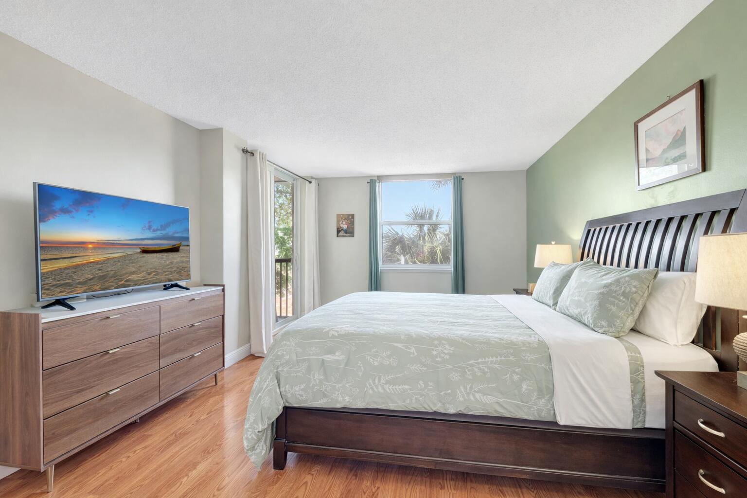 5260 Northwest 2nd Avenue, Unit 307 Boca Raton, FL 33487 - Photo 8 of 16 a bedroom with a large bed and a flat screen tv