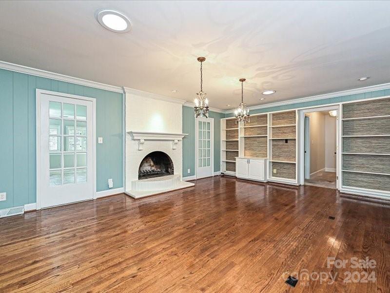 3711 High Ridge Road Charlotte, NC 28270 - Photo 14 of 39 an empty room with wooden floor fireplace and windows