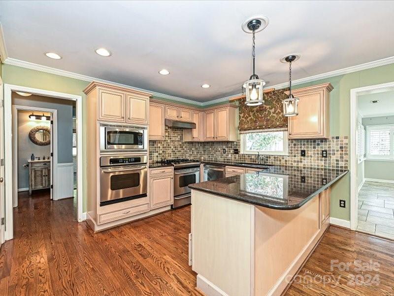 3711 High Ridge Road Charlotte, NC 28270 - Photo 16 of 39 a kitchen with stainless steel appliances kitchen island granite countertop a stove a sink and a refrigerator