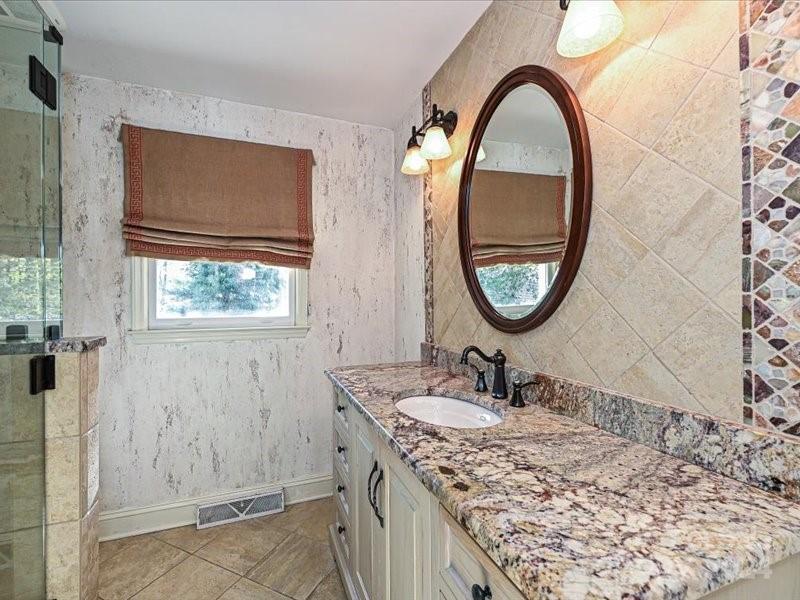 3711 High Ridge Road Charlotte, NC 28270 - Photo 24 of 39 a bathroom with a granite countertop sink a mirror and a shower