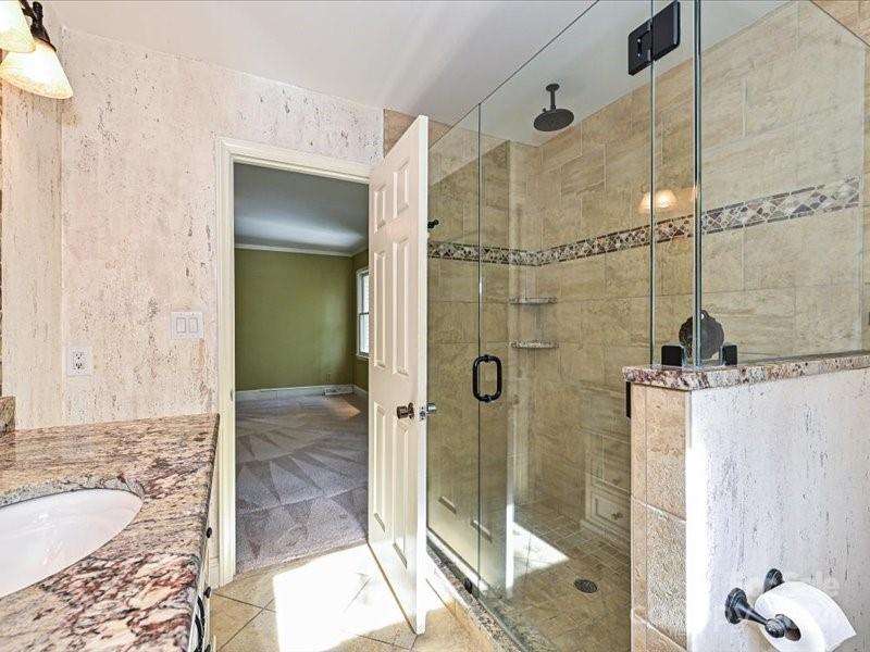 3711 High Ridge Road Charlotte, NC 28270 - Photo 25 of 39 a bathroom with a granite countertop shower mirror and a sink