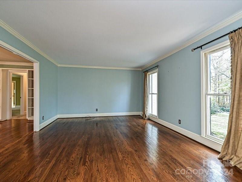 3711 High Ridge Road Charlotte, NC 28270 - Photo 10 of 39 a view of an empty room with wooden floor and a window