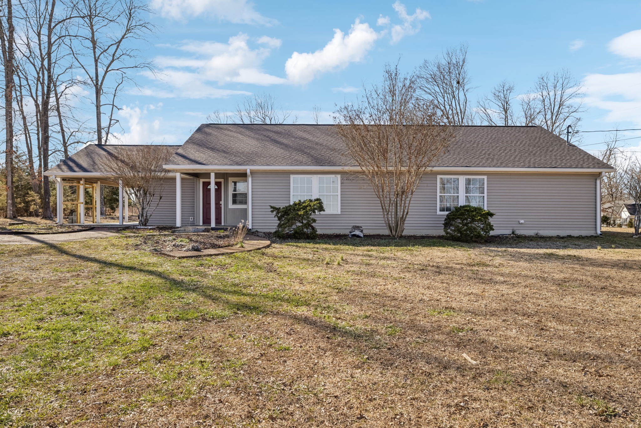 2185 Joe Brown Road Spring Hill, TN 37174 - Photo 3 of 96 a view of a white house next to a yard with large trees