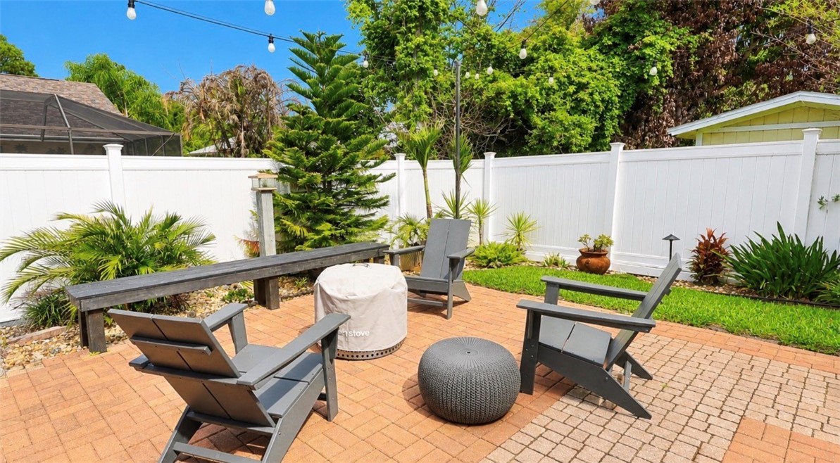 1771 Mistletoe Street Sebastian, FL 32958 - Photo 31 of 36 a view of a patio with table and chairs potted plants and palm tree