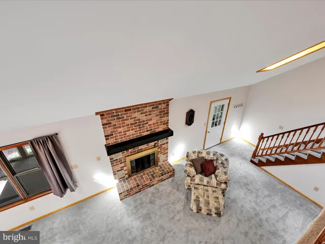 a living room with furniture a couch and a potted plant