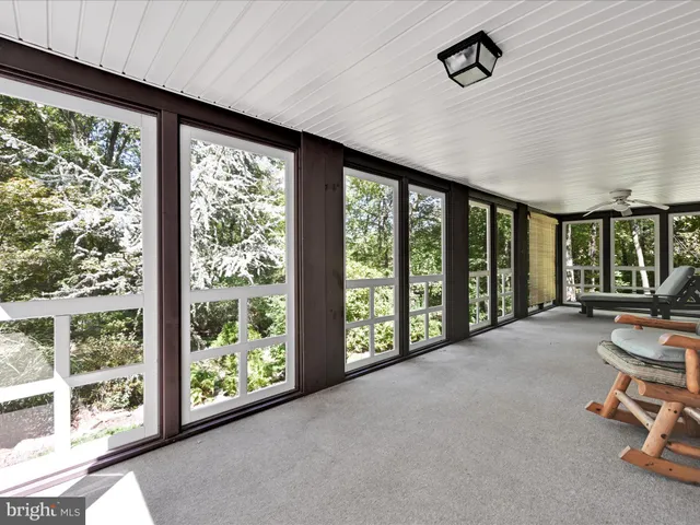 a living room with furniture and large windows