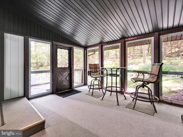 a view of a livingroom with furniture and a large window