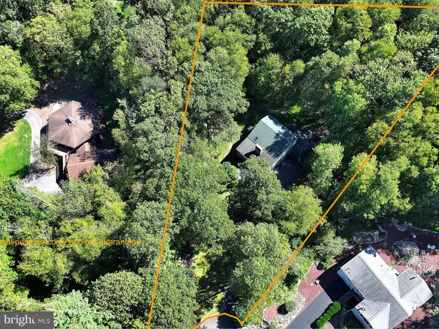an aerial view of a house with a yard and outdoor seating