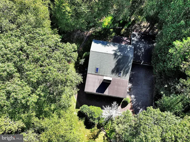 an aerial view of house with yard and outdoor seating