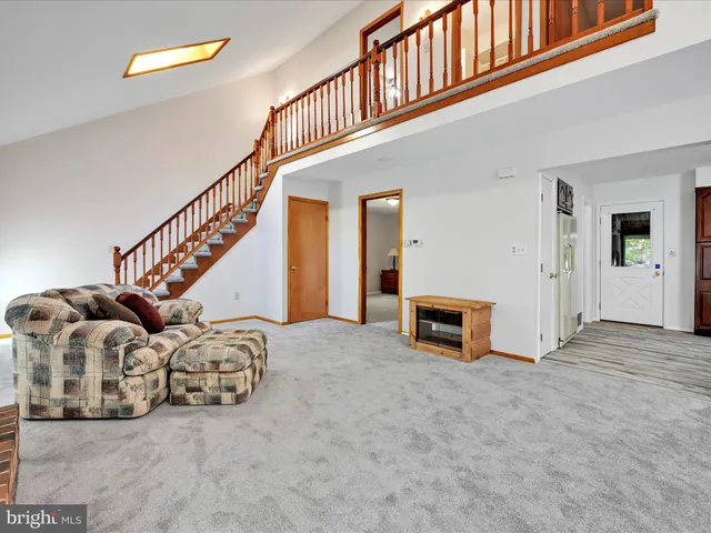 a view of an room with staircase and a ceiling fan