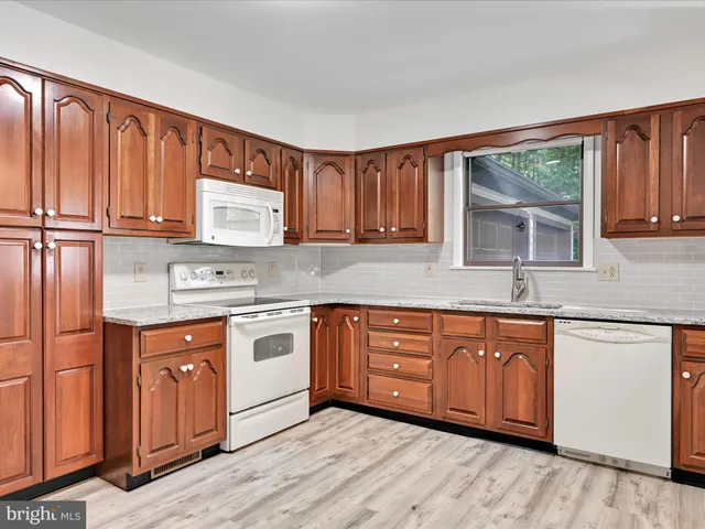 a view of a dining room with furniture and a chandelier