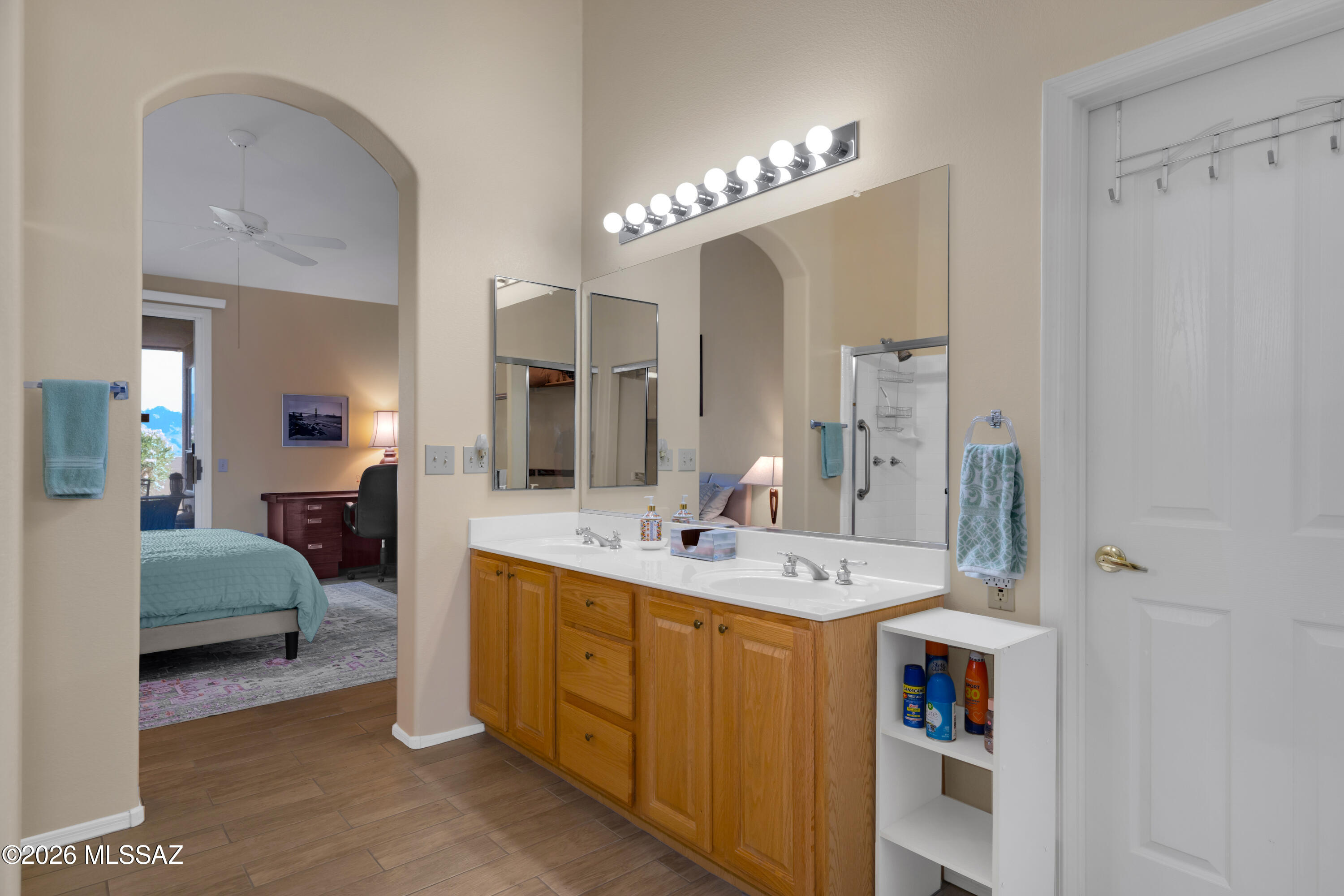 64351 East Wind Ridge Circle Tucson, AZ 85739 - Photo 21 of 41 a en suite bathroom with a double vanity sink a mirror and shower