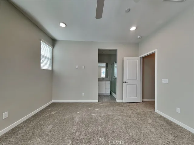 an empty room with closet and windows