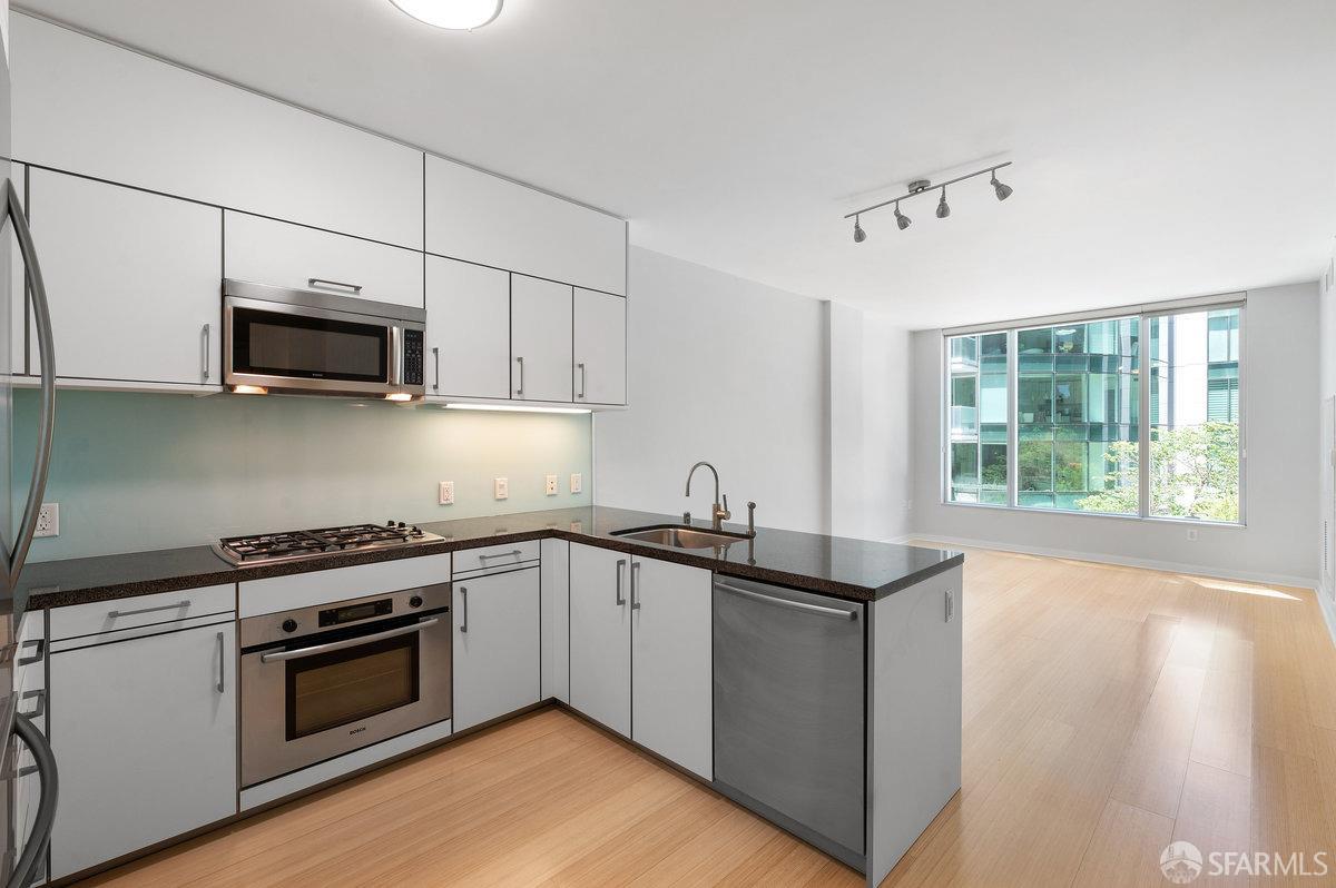 a kitchen with granite countertop a stove and a sink