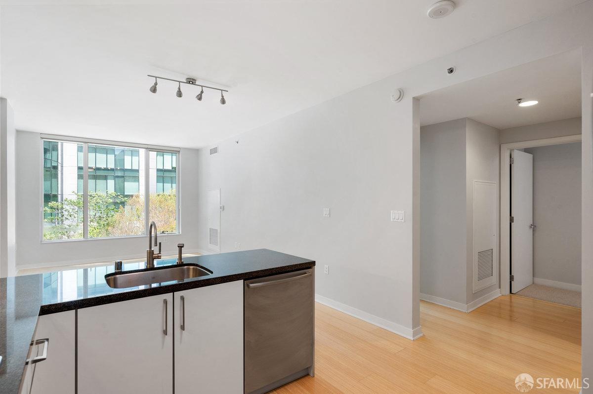 333 Main Street, Unit 4M San Francisco, CA 94105 - Photo 8 of 39 a kitchen with granite countertop a sink and a window