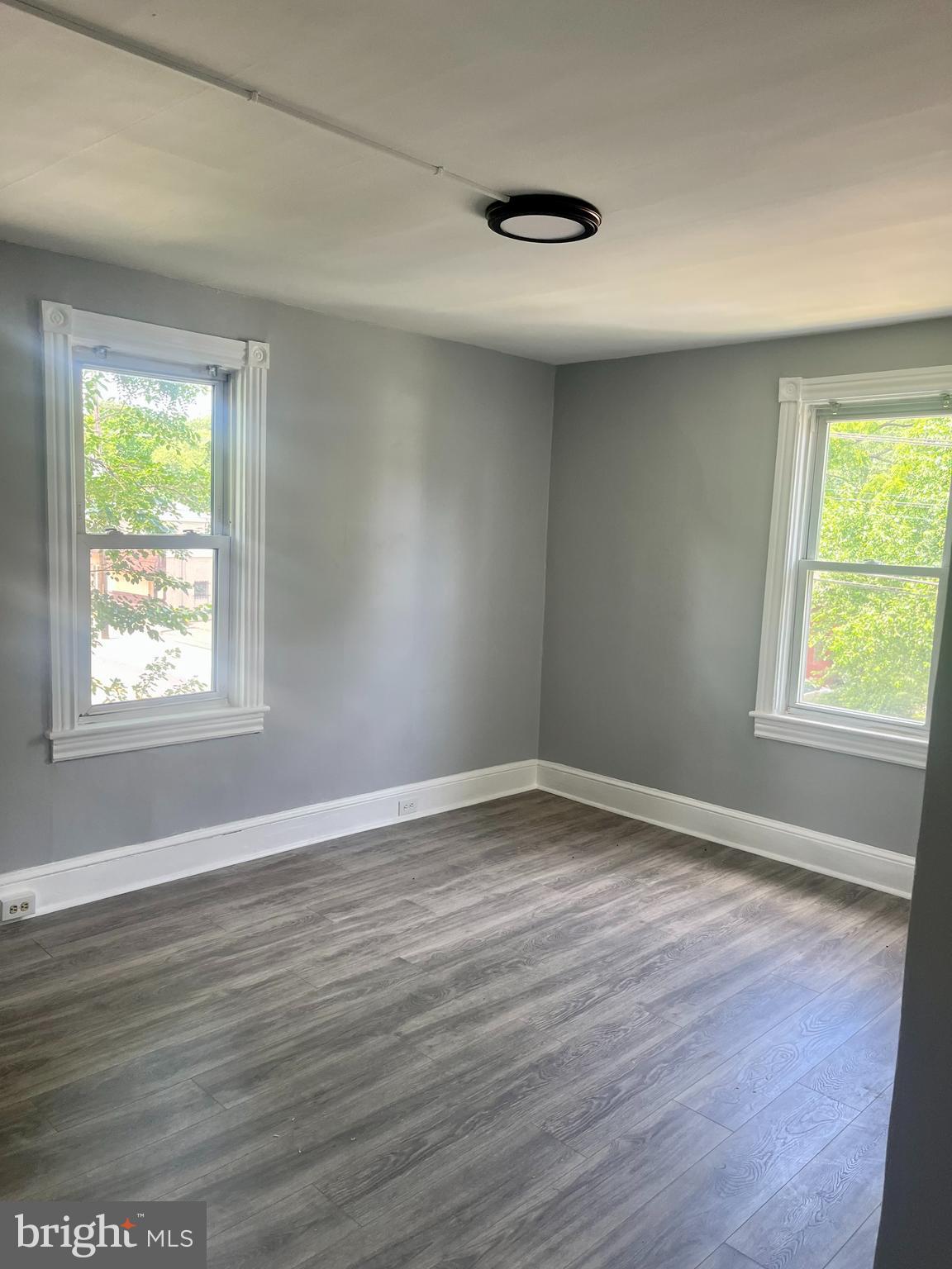 2 Beloit Avenue, Unit B Audubon, NJ 08106 - Photo 3 of 10 a view of an empty room with wooden floor and a window