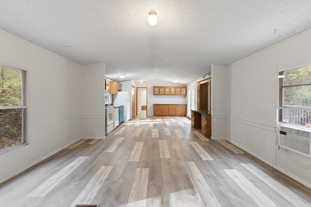 a big room with wooden floor and windows