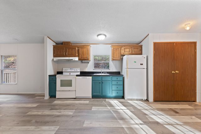 a kitchen with a refrigerator and a stove
