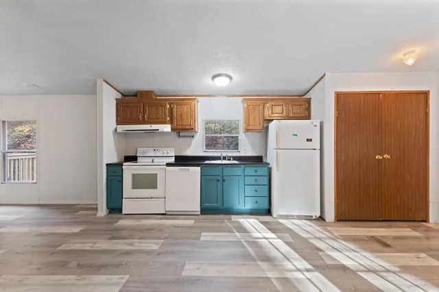 a kitchen with a refrigerator and a stove
