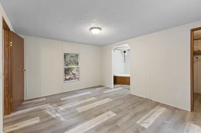 a view of a livingroom with an empty space and a ceiling fan