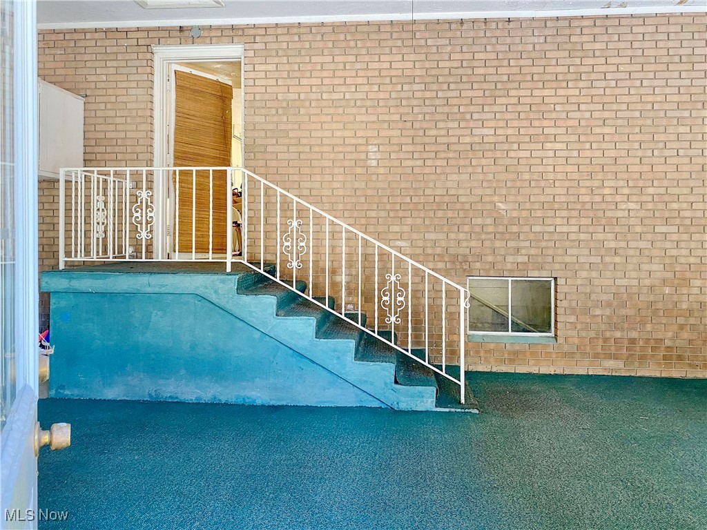 1034 Straub Road West Mansfield, OH 44904 - Photo 26 of 27 Stairway with carpet and brick wall