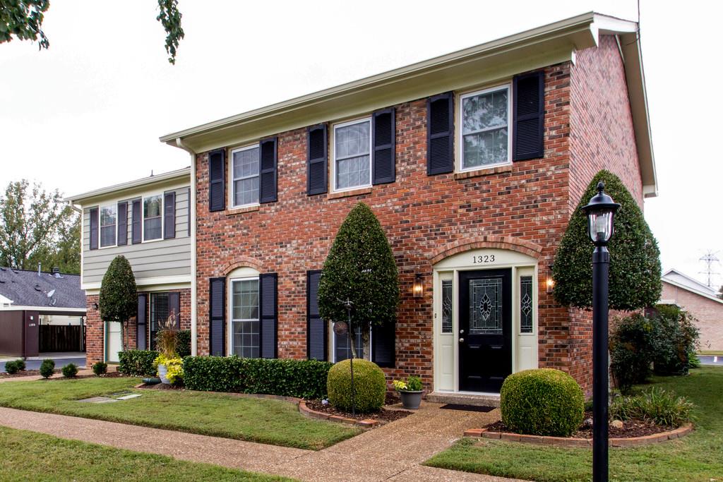 1323 General George Patton Road Nashville, TN 37221 - Photo 1 of 30 a front view of a house with garden and garage