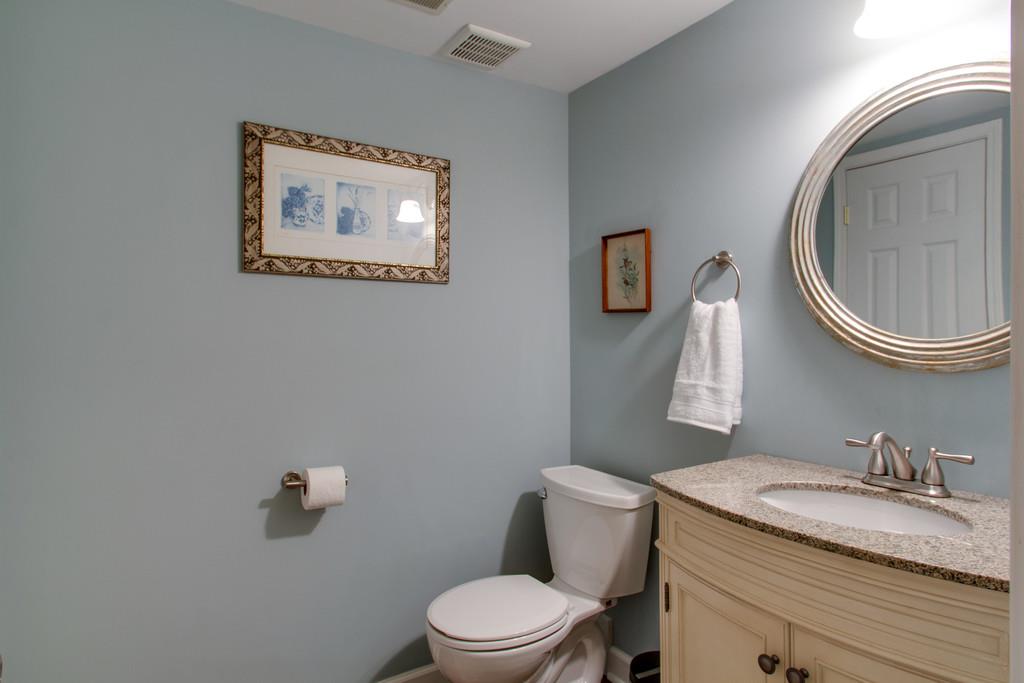 1323 General George Patton Road Nashville, TN 37221 - Photo 20 of 30 a bathroom with a granite countertop toilet a sink and mirror