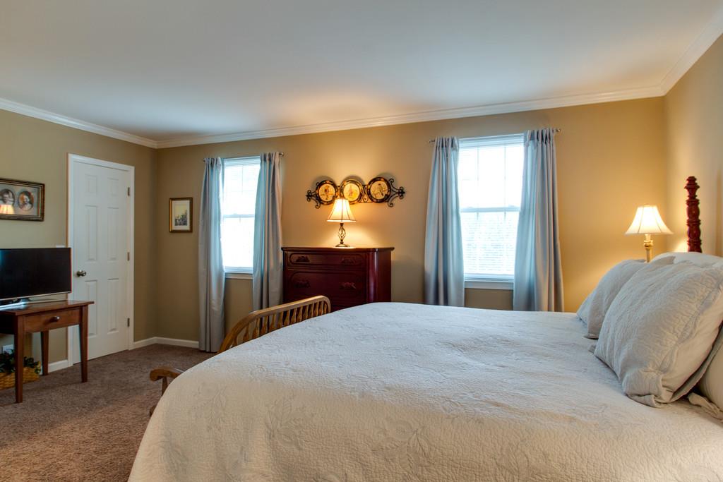 1323 General George Patton Road Nashville, TN 37221 - Photo 22 of 30 a bedroom with a bed and a flat screen tv