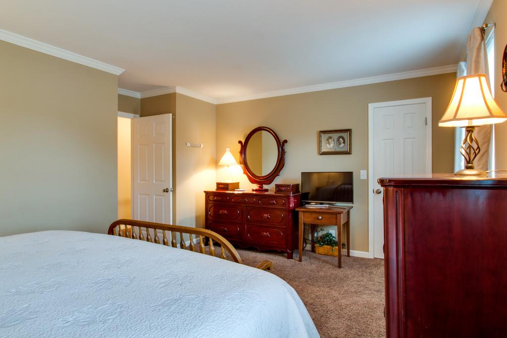 1323 General George Patton Road Nashville, TN 37221 - Photo 23 of 30 a bedroom with a bed and a dresser