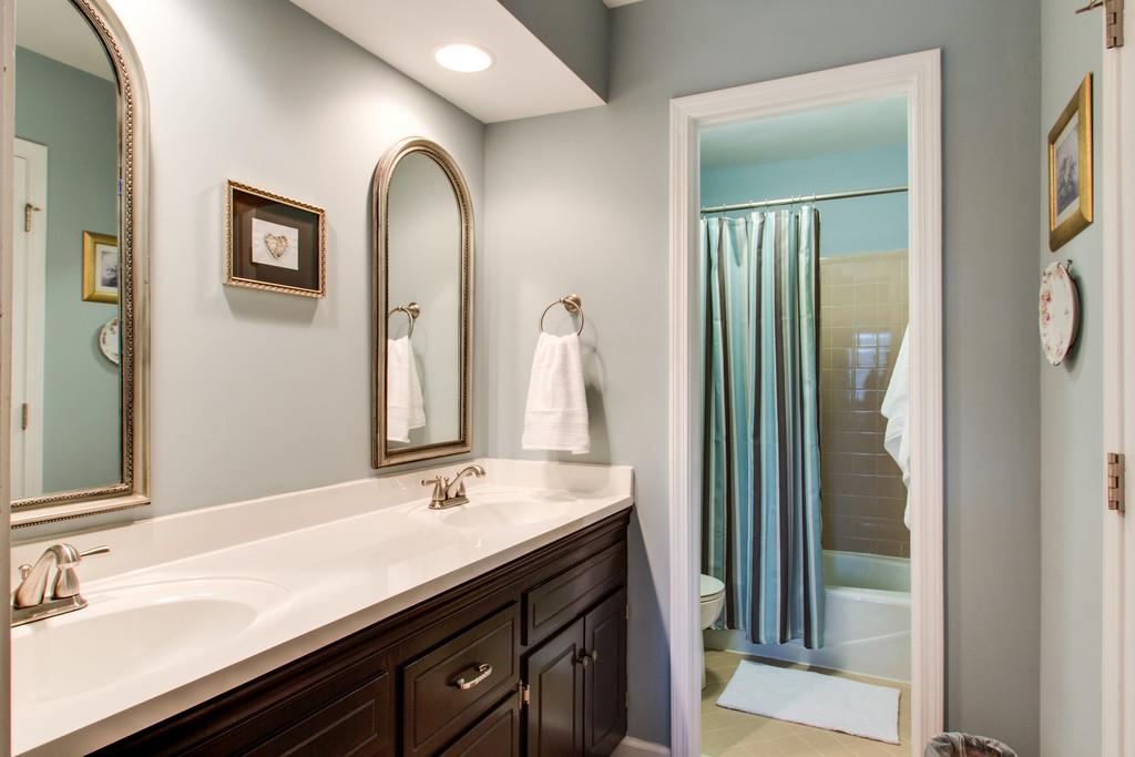 1323 General George Patton Road Nashville, TN 37221 - Photo 24 of 30 a bathroom with a double vanity sink and a mirror