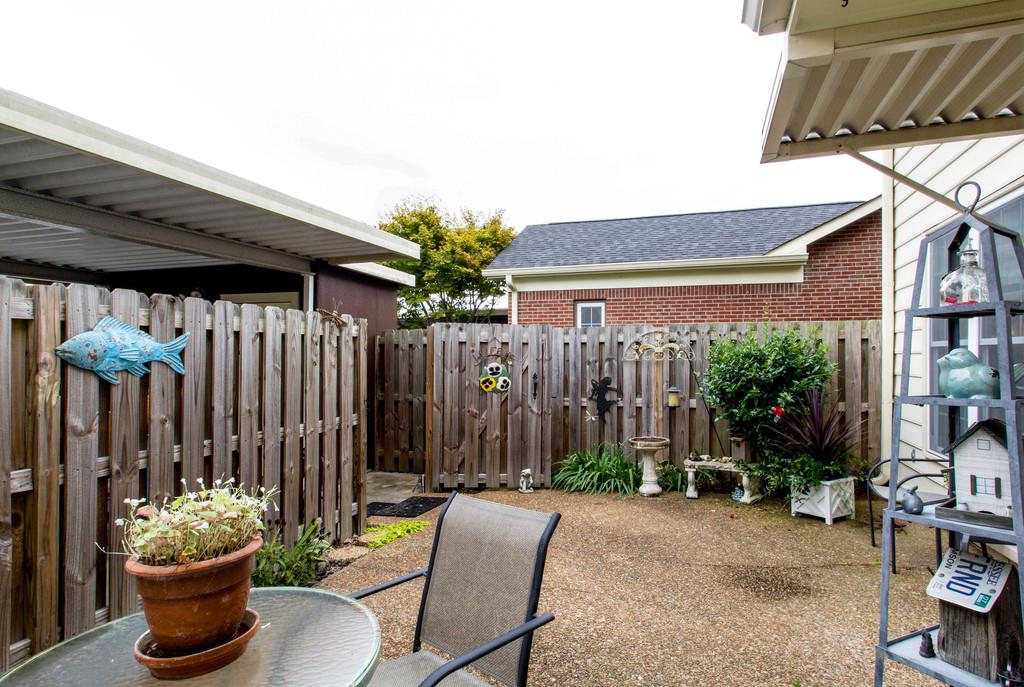 1323 General George Patton Road Nashville, TN 37221 - Photo 30 of 30 a view of a patio with table and chairs and potted plants