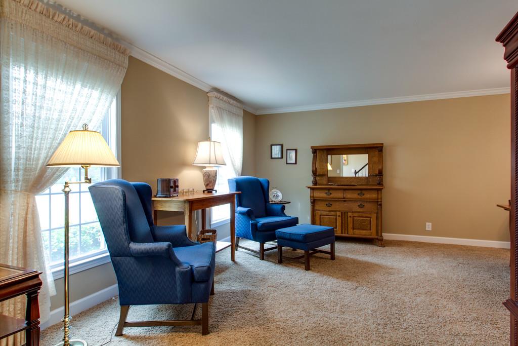1323 General George Patton Road Nashville, TN 37221 - Photo 5 of 30 a living room with furniture a fireplace and a flat screen tv