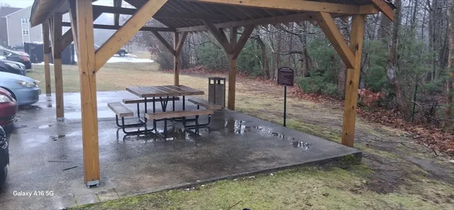 a view of a patio with a table chairs and a backyard