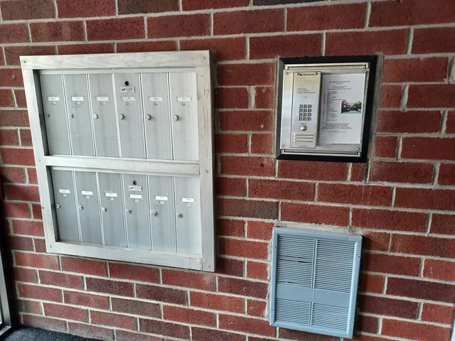 a view of a hallway with wooden floor and a window