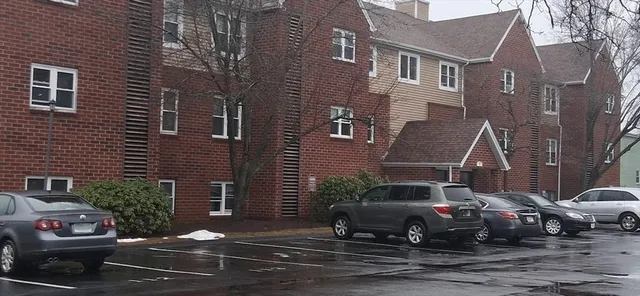 a car parked in front of a brick house