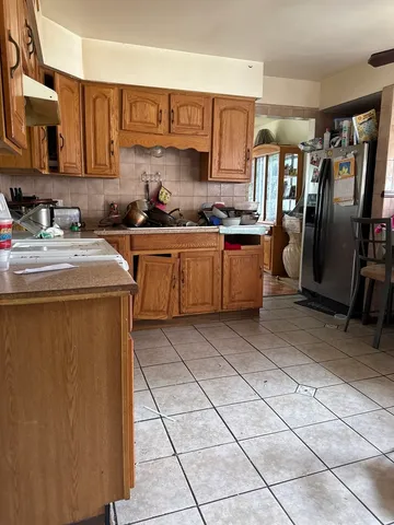 a kitchen with stainless steel appliances granite countertop a refrigerator sink and cabinets