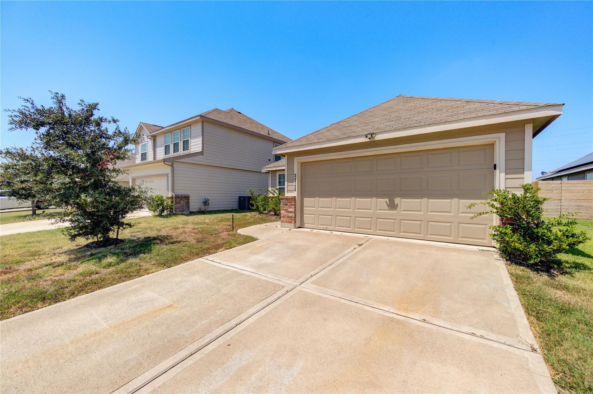 24726 Signorelli Way Katy, TX 77493 - Photo 1 of 18 a front view of a house with a yard and garage