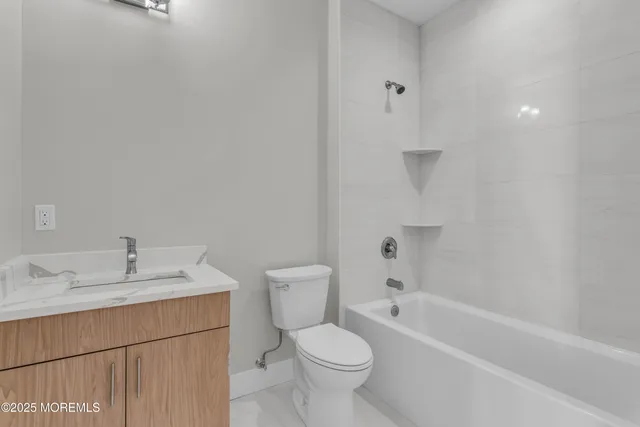 a bathroom with a sink toilet and bathtub