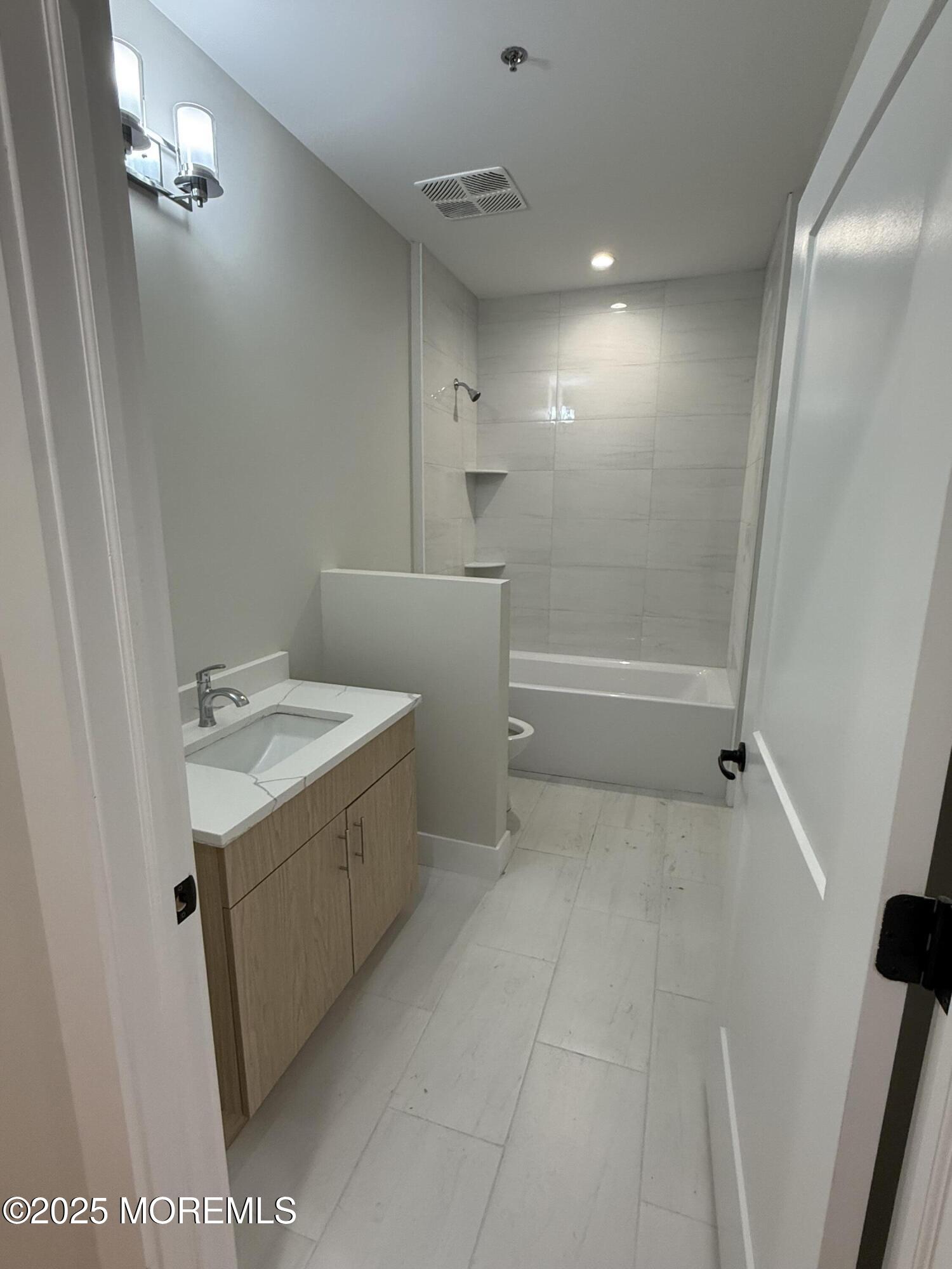 7 Broad Street, Unit 4 Red Bank, NJ 07701 - Photo 16 of 23 a bathroom with a sink a toilet and shower