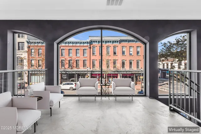 a living room with furniture and floor to ceiling windows