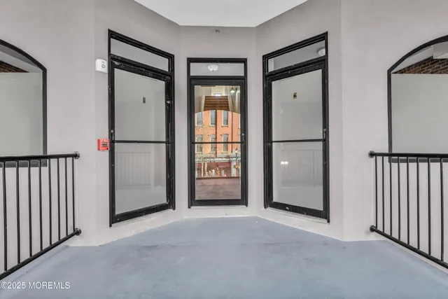 a view of empty room with wooden floor and cabinet