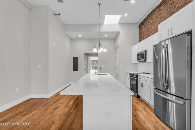 a kitchen with stainless steel appliances a refrigerator and a stove