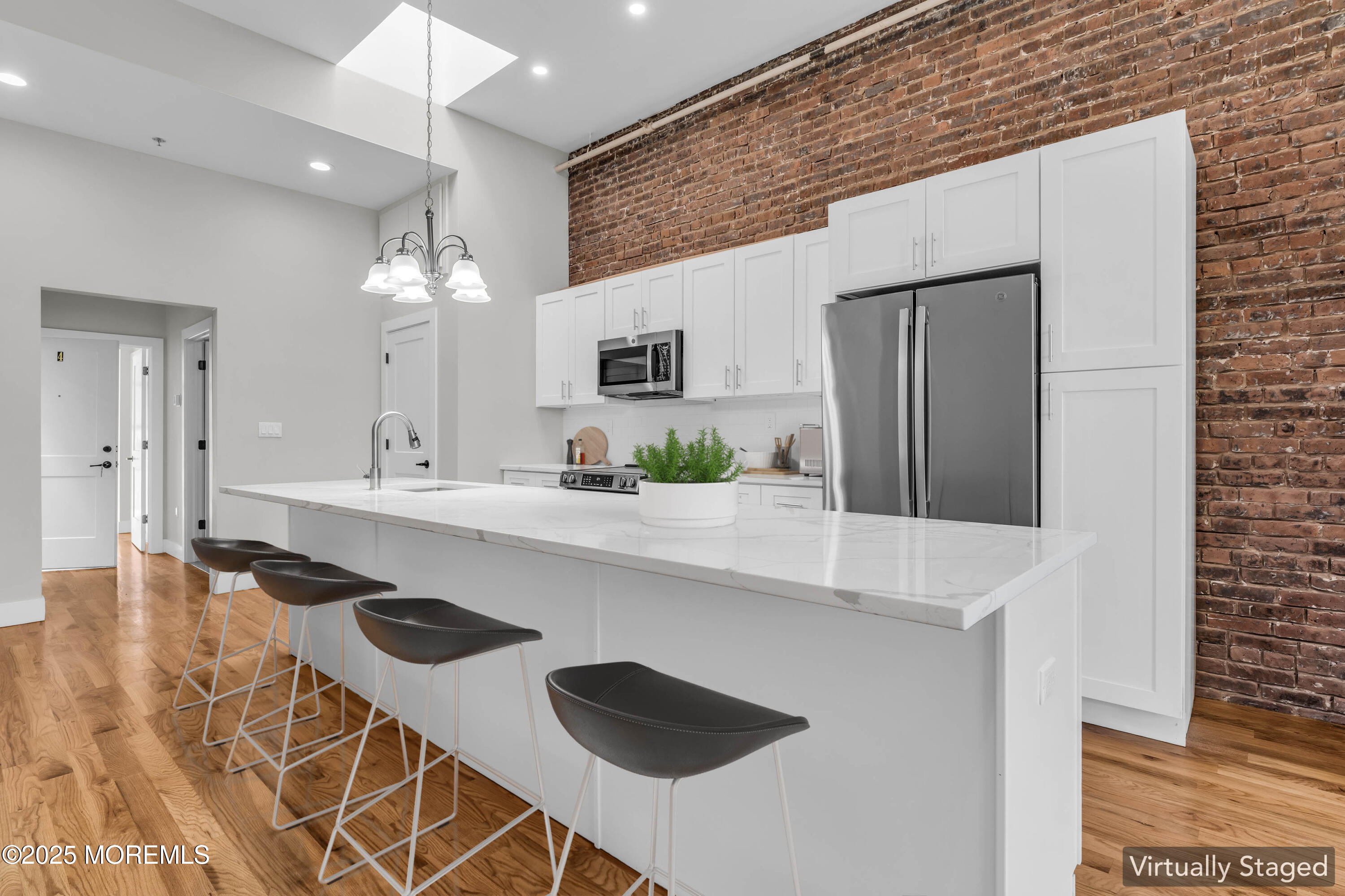 7 Broad Street, Unit 4 Red Bank, NJ 07701 - Photo 8 of 23 a kitchen with kitchen island stainless steel appliances a sink and a refrigerator