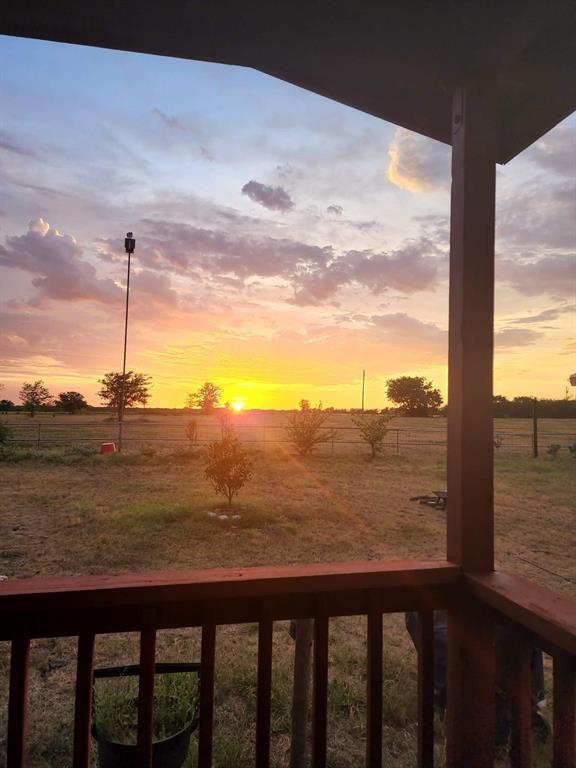 2234 County Road 1056 Celeste, TX 75423 - Photo 7 of 8 Yard at dusk featuring a balcony