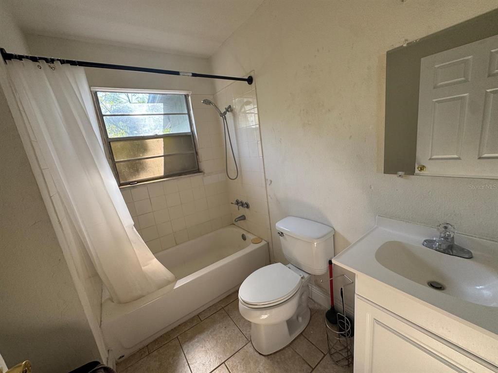 140 East 12th Street Apopka, FL 32703 - Photo 12 of 13 a bathroom with a sink toilet and shower